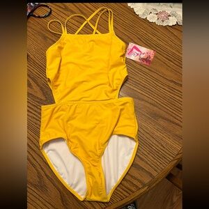 Yellow one piece girls bathing suit with cut outs on waist.